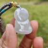 a hand holding a bead