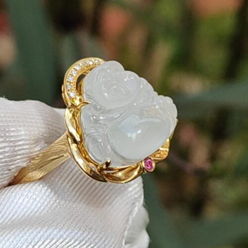 a ring with a carved white stone in a gold ring