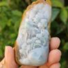 a hand holding a piece of stone