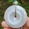 a hand holding a white round object