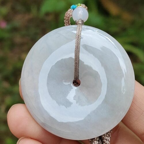 a hand holding a white round object