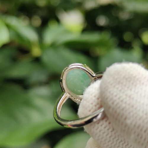 a hand in a glove holding a ring