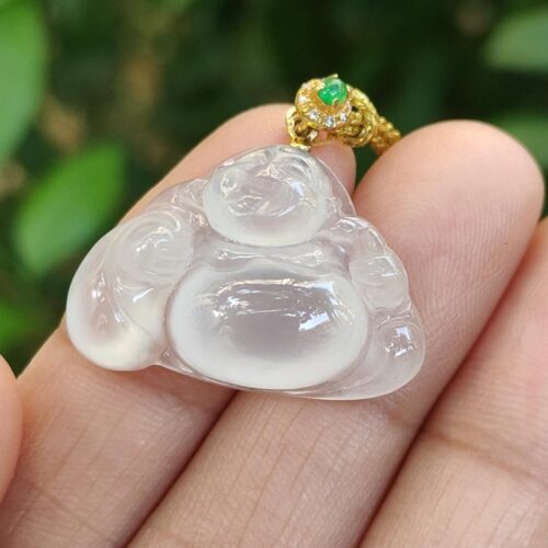 a hand holding a clear plastic pendant