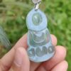 a hand holding a blue pendant