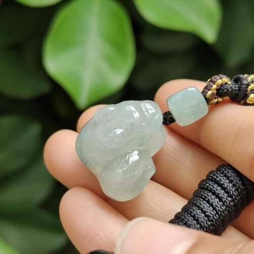 a hand holding a necklace