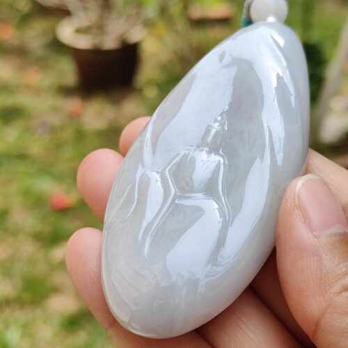 a hand holding a white stone