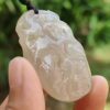 a hand holding a white stone