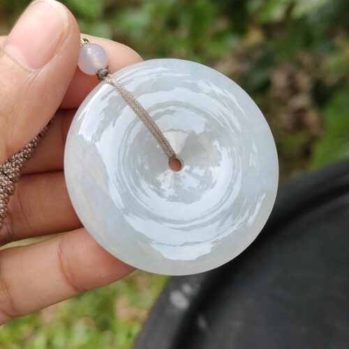 a hand holding a white round object