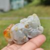 a hand holding a small stone