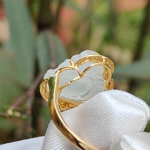 a gold ring with a white stone in the middle