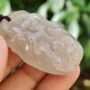 a hand holding a white stone