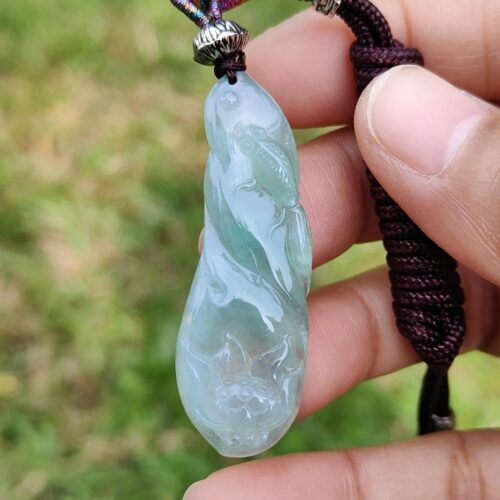 a hand holding a necklace