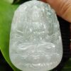 a hand holding a carved white jade