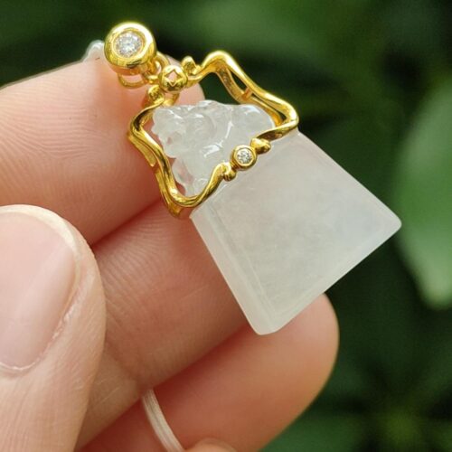 a hand holding a necklace