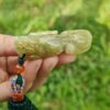 a hand holding a green object
