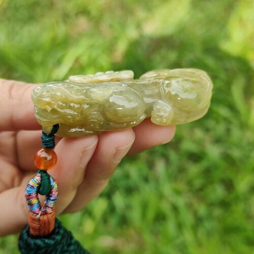 a hand holding a green object