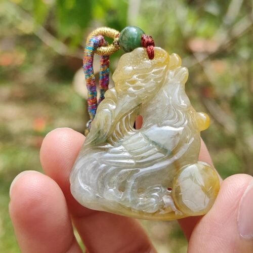 Una mano sosteniendo un colgante de jade.