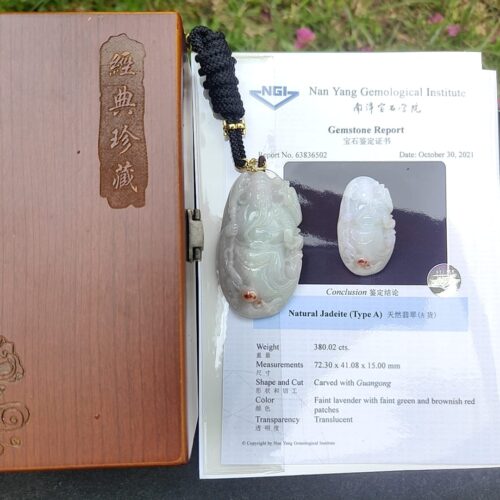 a jade pendant on a book