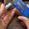 a person holding a blue device