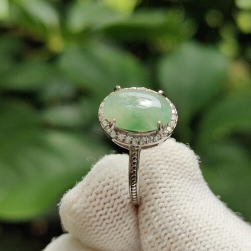 a hand wearing a glove with a ring