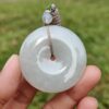 a hand holding a white round object
