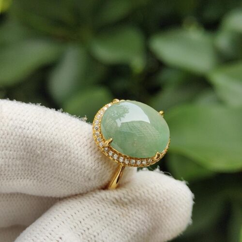 a hand wearing a glove with a ring