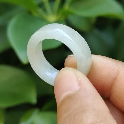 एक हाथ में सफ़ेद अंगूठी पकड़े हुए