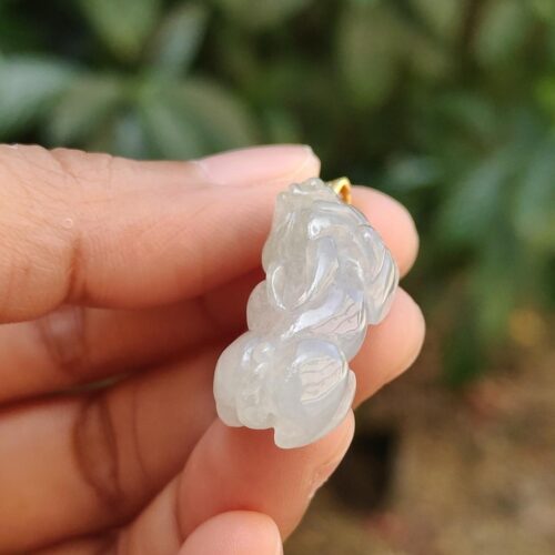 a hand holding a small white object