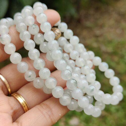 a person holding a necklace