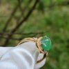 a ring with a green stone on it
