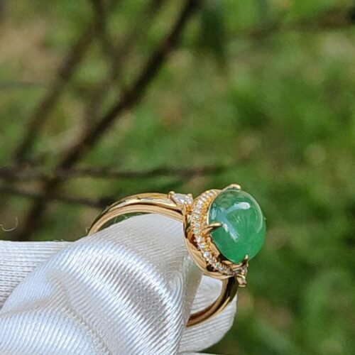 a ring with a green stone on it