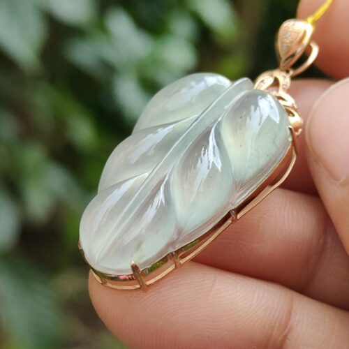 a hand holding a gold necklace