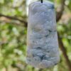 a jade pendant from a tree