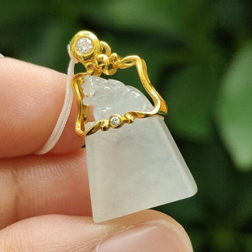 a hand holding a pendant