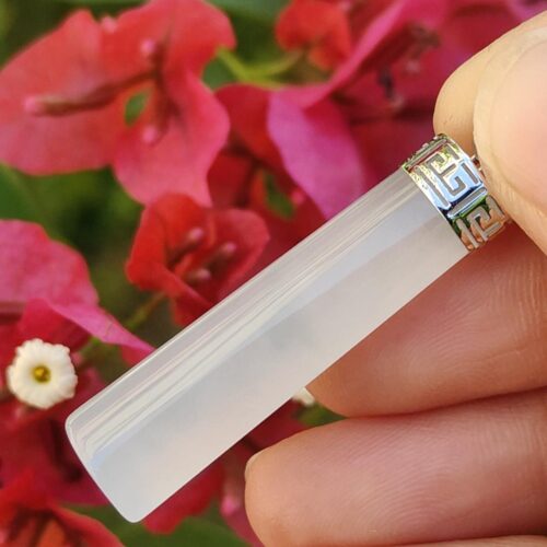 a hand holding a white crystal