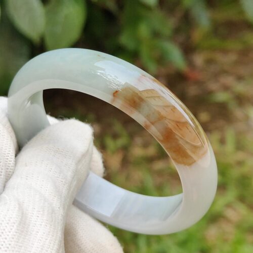 a hand in glove holding a ring