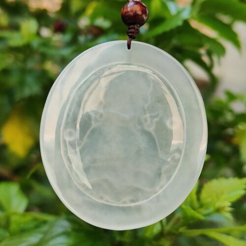a white round object with a bead from a string