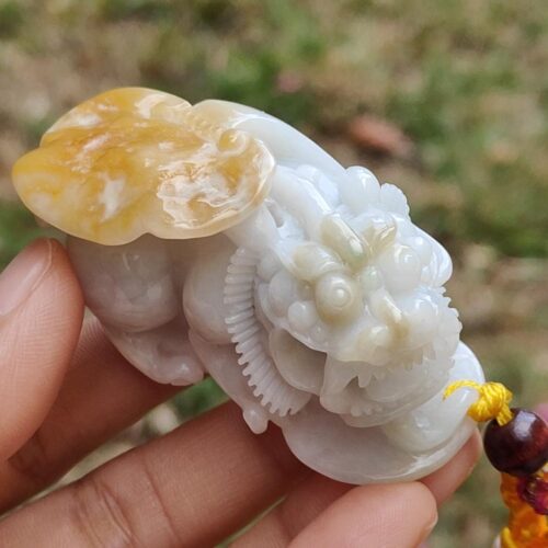 a hand holding a small white stone figure