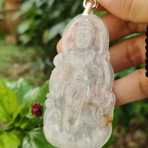 Una mano sosteniendo un colgante de jade.