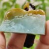 a hand holding a piece of jade