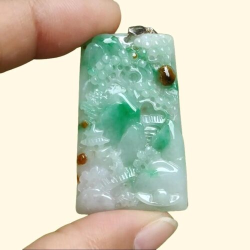 a hand holding a green and white rectangular object