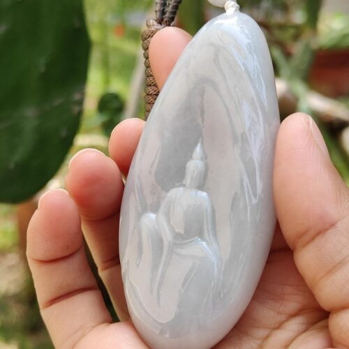 a hand holding a white stone