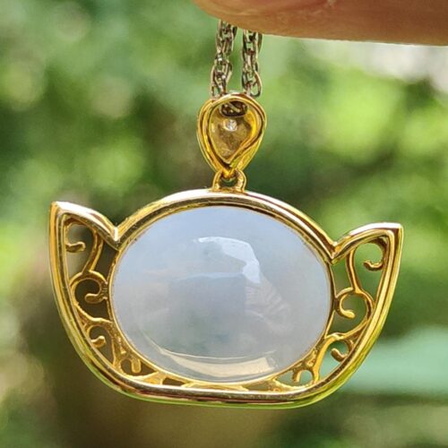 a hand holding a necklace