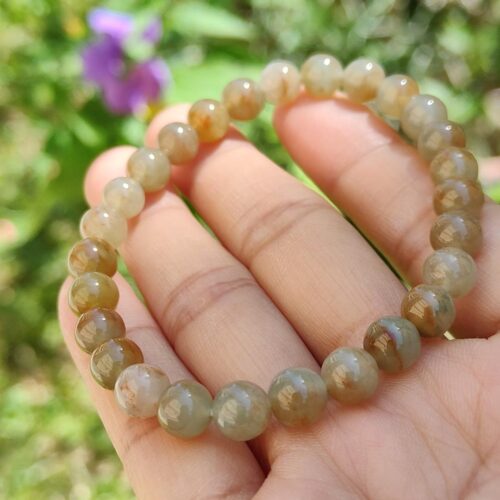 a hand holding a bracelet