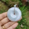 a hand holding a white round object