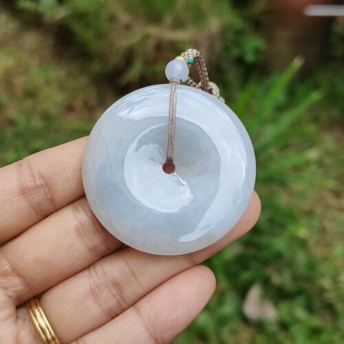 a hand holding a white round object
