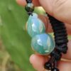 a hand holding a bead