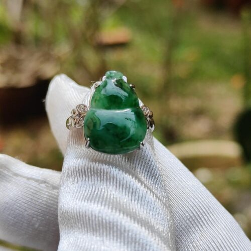 a green jade ring on a white glove