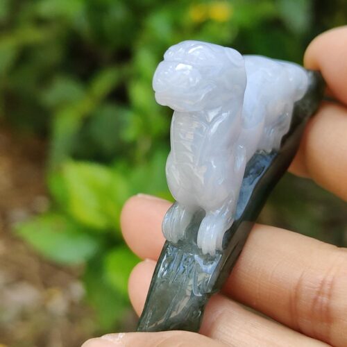 a hand holding a small stone sculpture