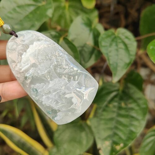 a hand holding a piece of white stone
